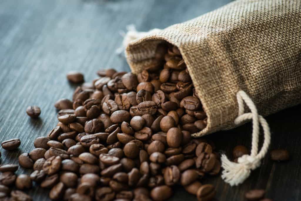 Coffee beans spilling out of a bag.